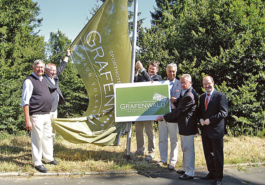 Geschäftsführer und Eigentümer hissen die Fahne mit dem neue Logo des Sporthotels & Resort Grafenwald